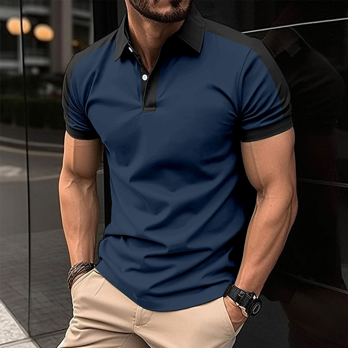 Man wearing a navy blue polo shirt with black accents in an urban setting