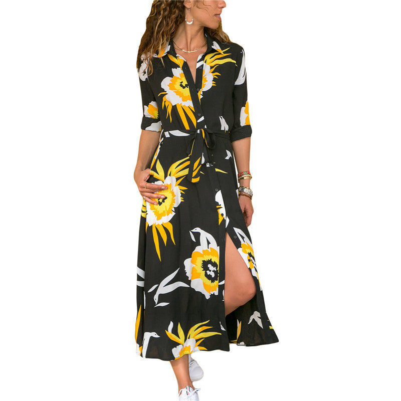 Woman wearing a black dress with yellow floral pattern on a white background