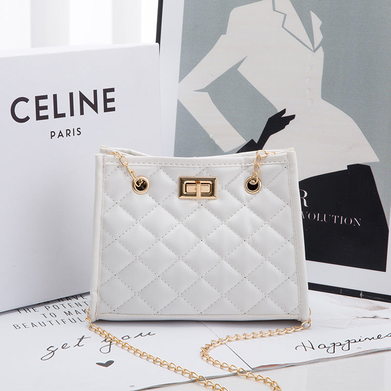 White quilted handbag with gold chain on a magazine with Celine branding.