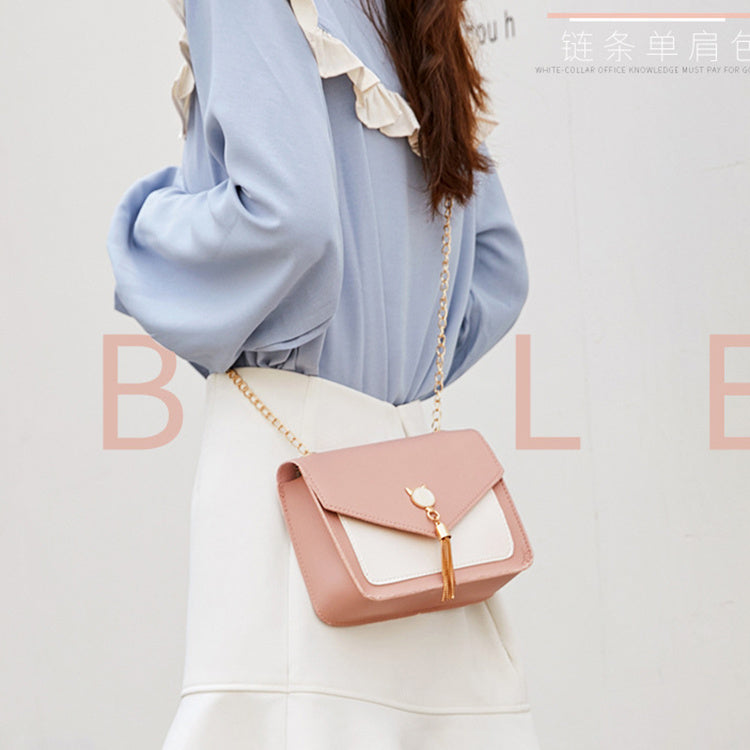 Person wearing a light blue shirt and white pants with a pink handbag on a light gray background