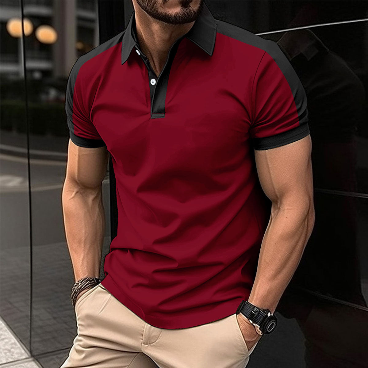 Man wearing a red and black polo shirt with beige pants in an urban setting