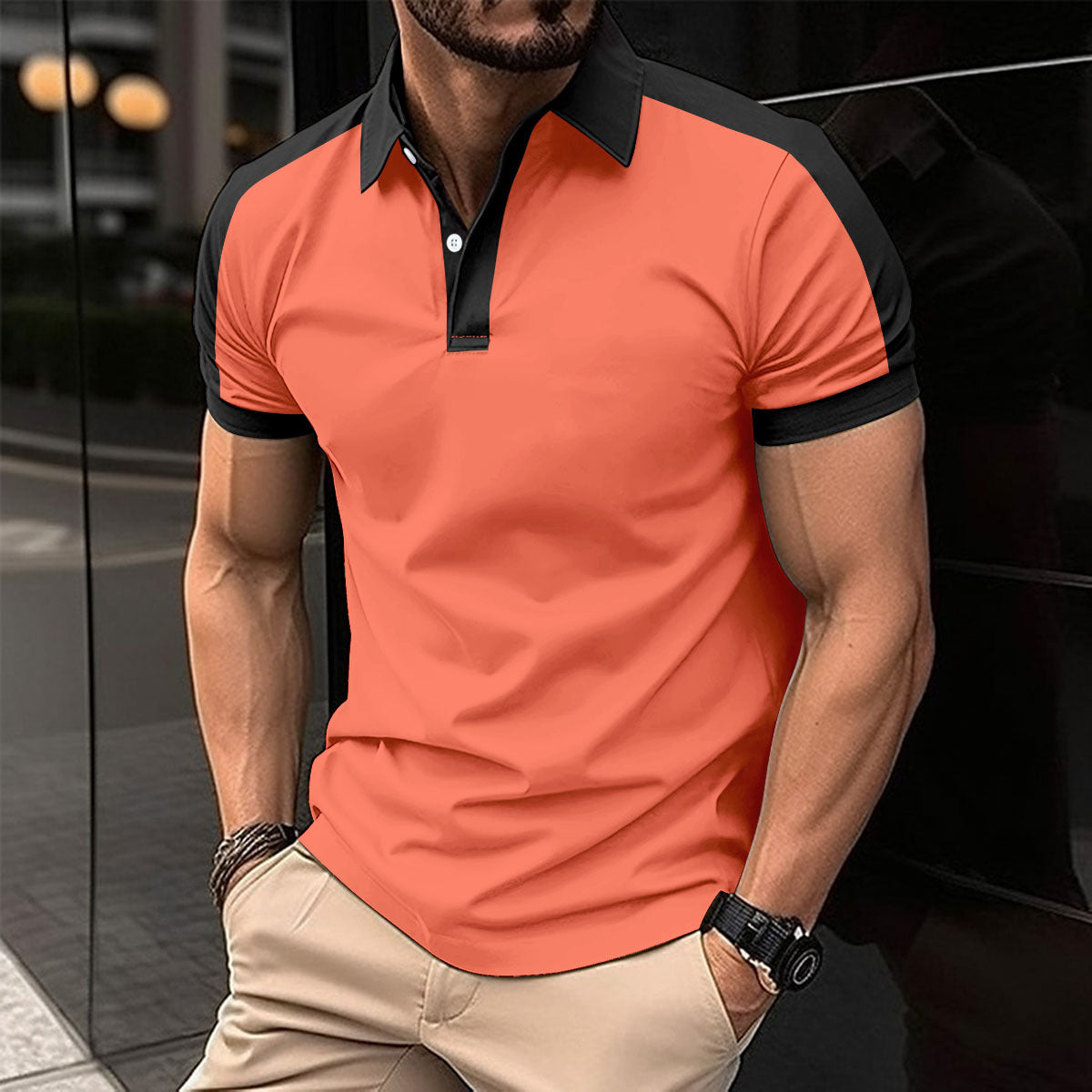 Man wearing an orange polo shirt with black accents in an urban setting