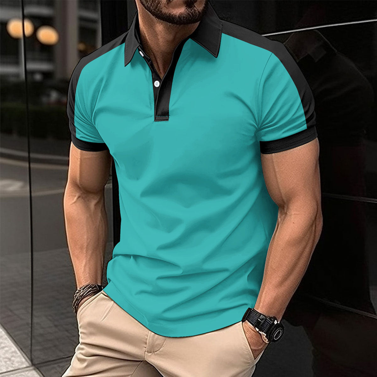 Man wearing a turquoise polo shirt with black accents in an urban setting