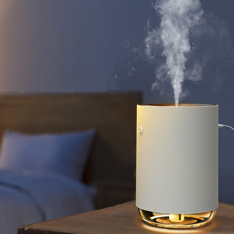 White humidifier emitting steam in a bedroom setting with a blue wall and bed in the background.