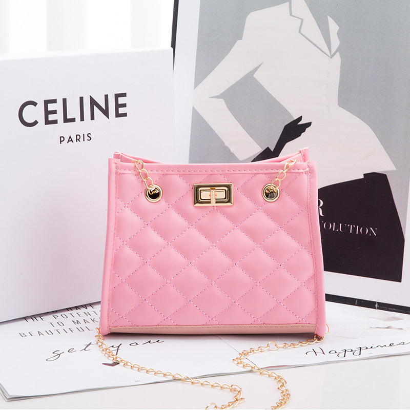 Pink quilted handbag with gold chain on a magazine with Celine branding