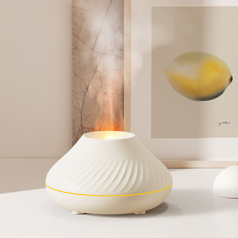 White diffuser on a table with abstract art in the background