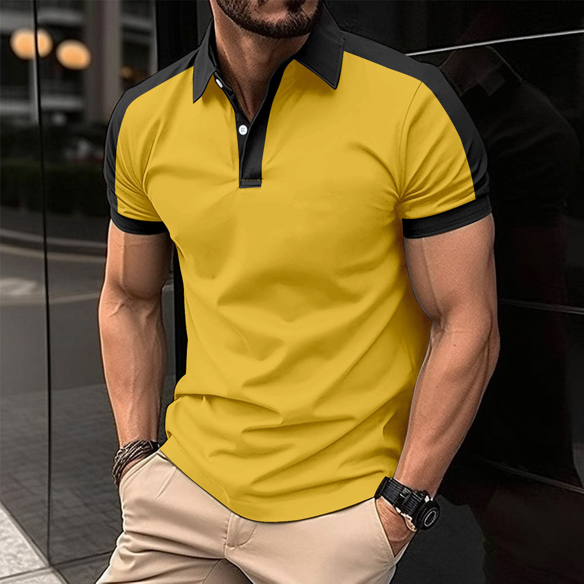 Man wearing a yellow polo shirt with black accents in an urban setting
