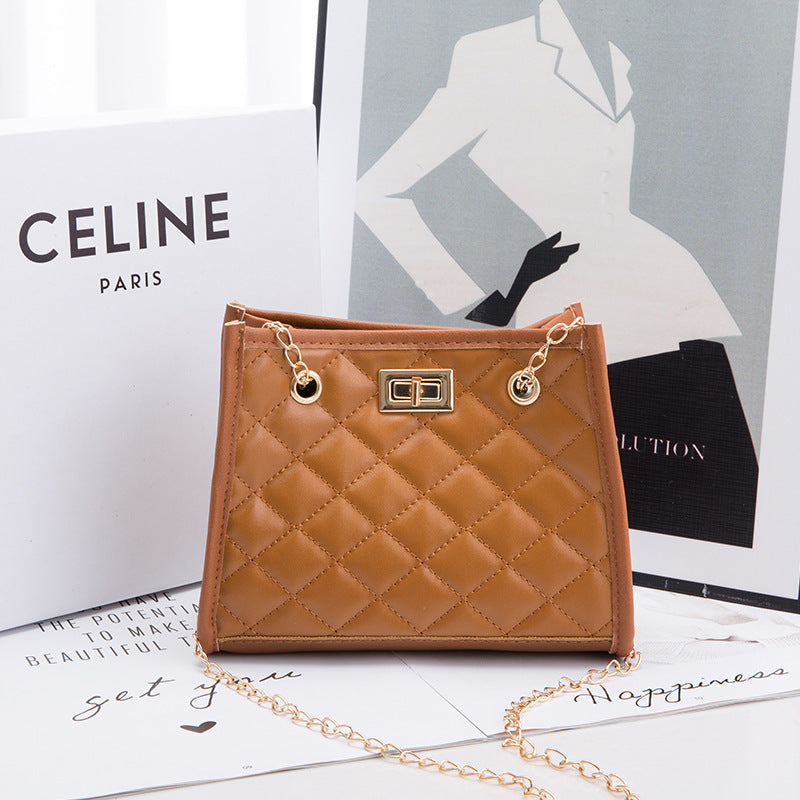 Quilted brown handbag with gold chain on a white surface with 'CELINE' branding.
