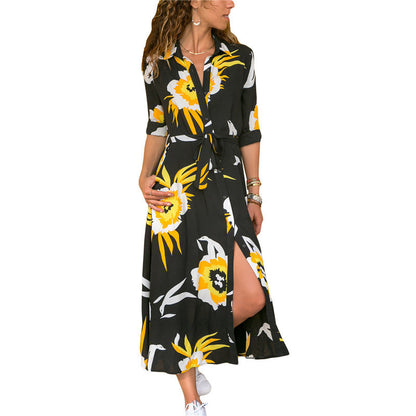 Woman wearing a black dress with yellow floral pattern on a white background
