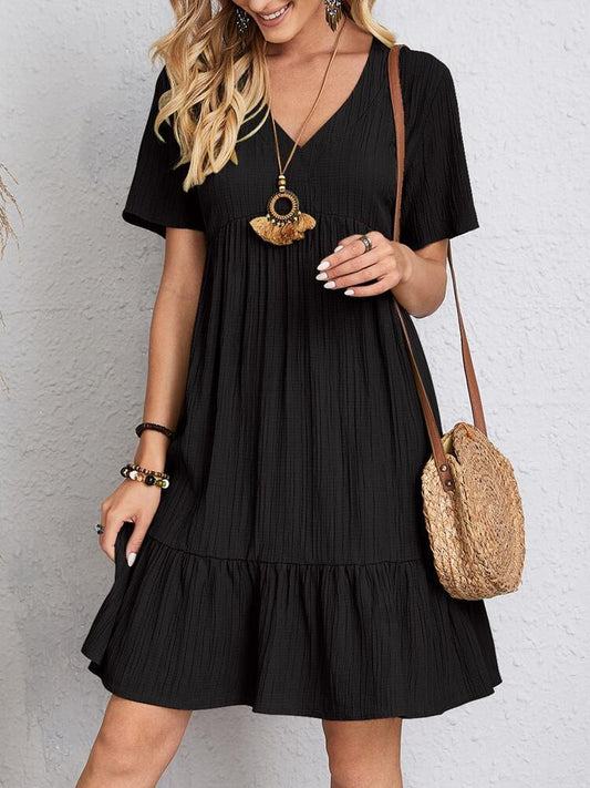 Woman wearing a black dress with a white background