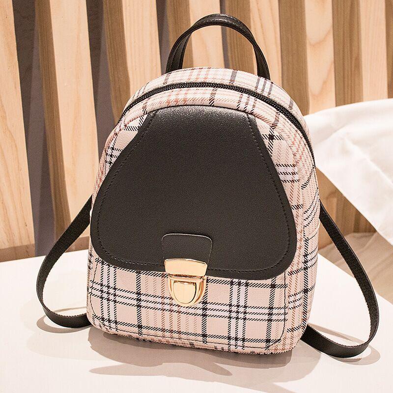 Plaid pattern backpack with black accents on a neutral background