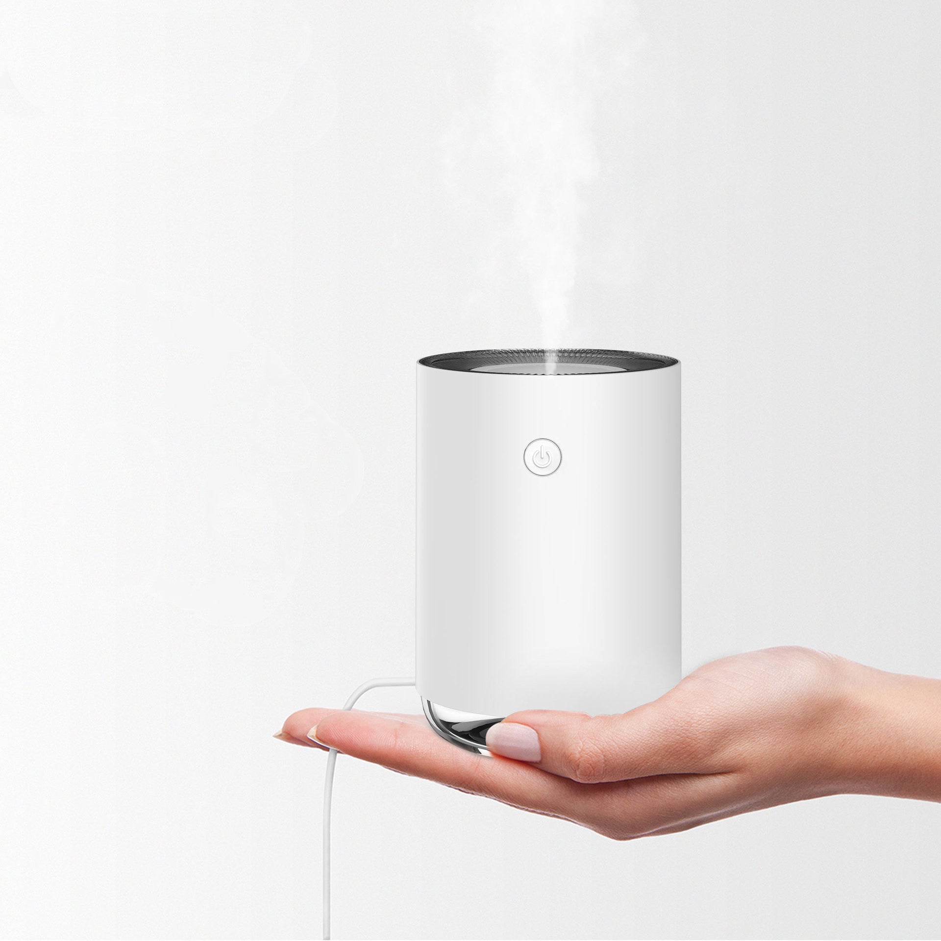 Hand holding a white cylindrical device with steam coming out on a light gray background