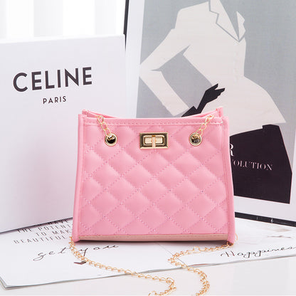 Pink quilted handbag with gold chain on a magazine with Celine branding