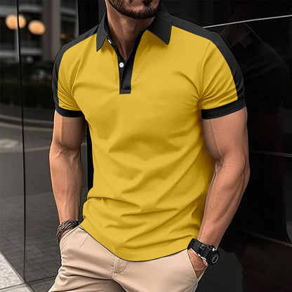 Man wearing a yellow polo shirt with black accents in an urban setting